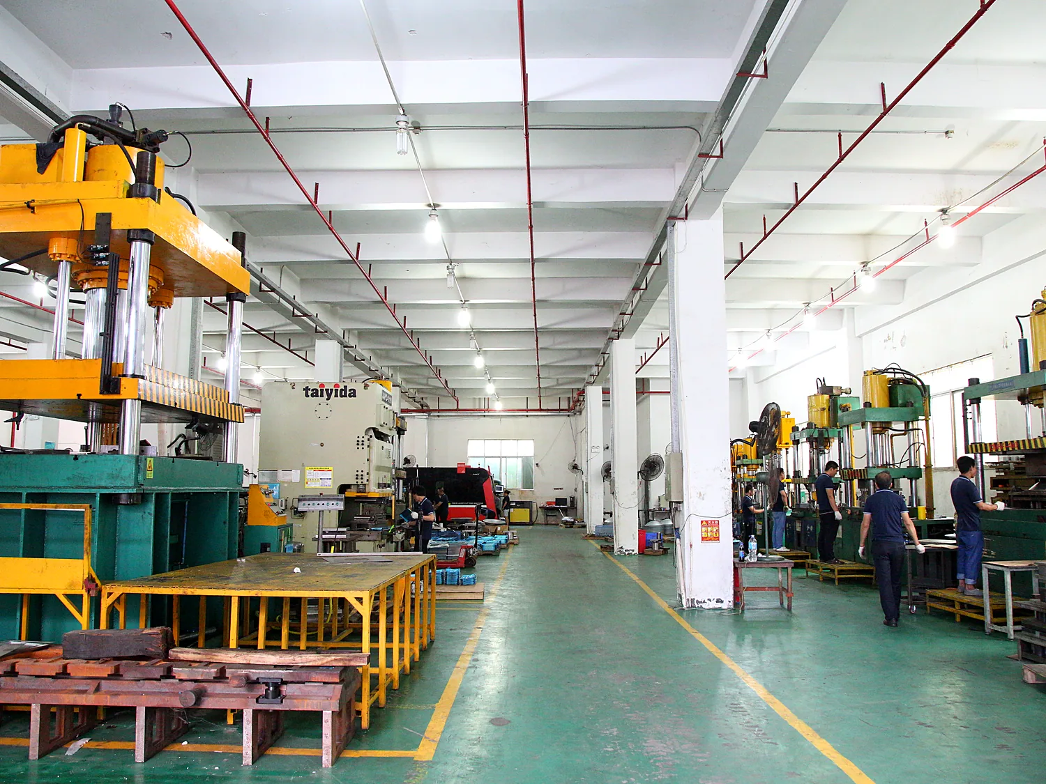 Long stamping hall with overhead cranes and presses running down both sides