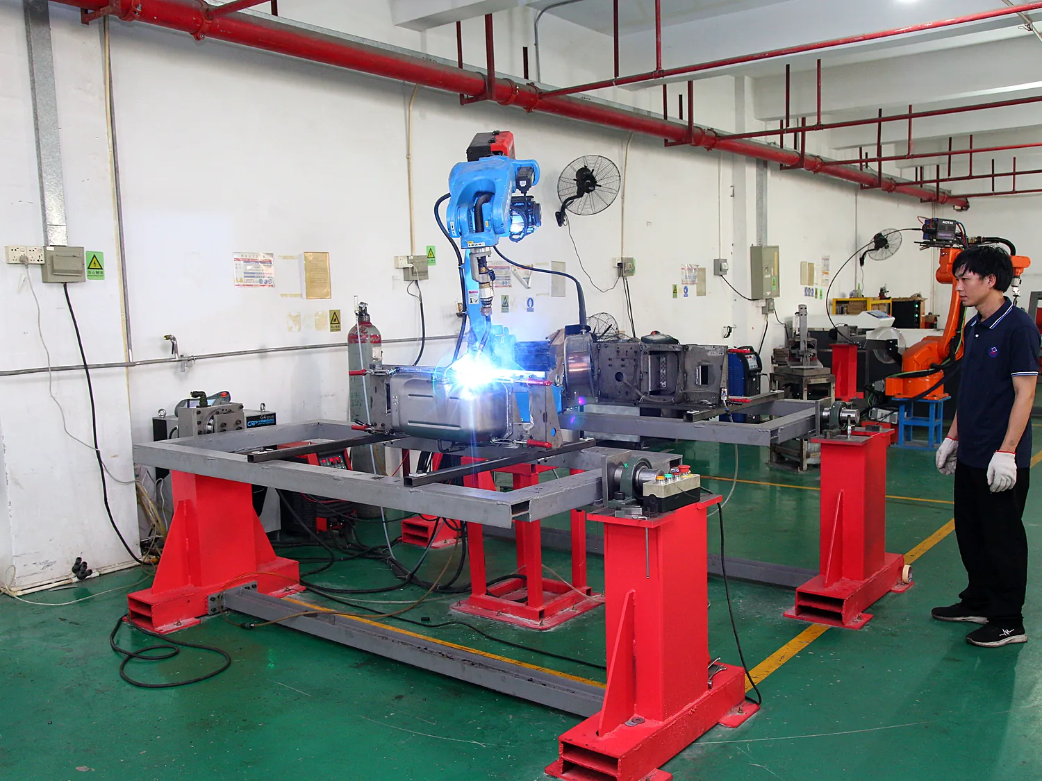 Robot welding a metal assembly with the arc visible